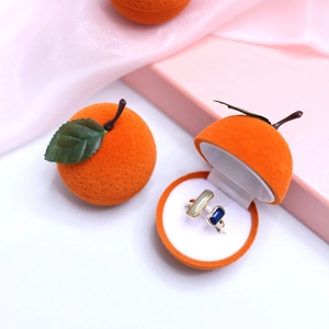 Creative orange-shaped jewelry box with velvet texture and silver adjustable gemstone ring