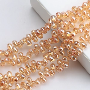 Macro detail of faceted champagne gold teardrop crystal glass beads for jewelry making