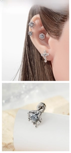 Close-up of heart-shaped titanium steel earring with zircon inlay and screw back detail