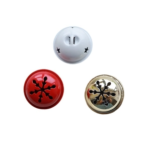 Three metal Christmas bells in white, red, and gold with cutout star and snowflake patterns