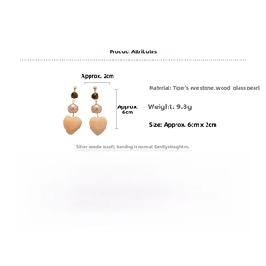 Detail view of heart-shaped wooden earrings with tiger eye and pearls, size 6cm x 2cm