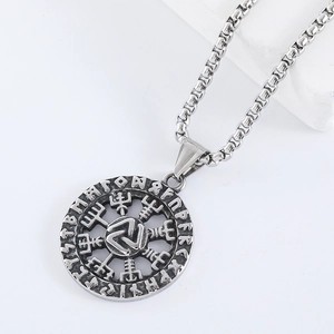 Detailed view of silver stainless steel pendant with engraved Nordic Viking runes symbols
