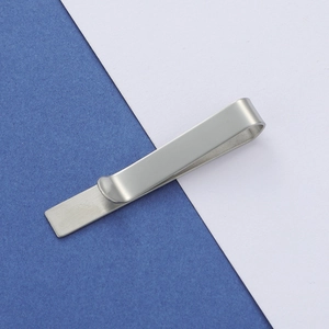 Close-up of silver stainless steel tie clip with premium brushed metal texture finish