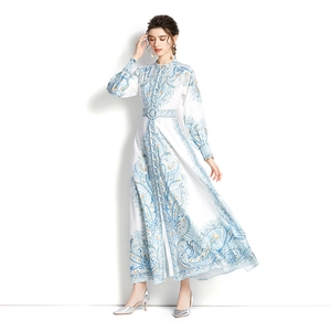 Elegant long-sleeved maxi dress with blue baroque print and waist belt on white background