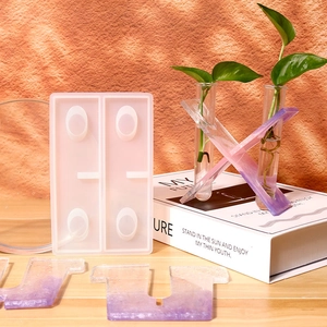 Detailed view of DIY silicone resin mold for flower tubes with purple letter U and X samples