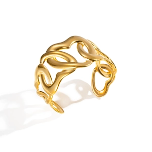 Detailed top view of gold-tone cutout interlocking cuff bracelet with polished finish