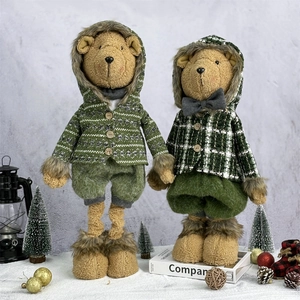 Christmas teddy bear plush dolls in green winter outfits with festive holiday ornaments