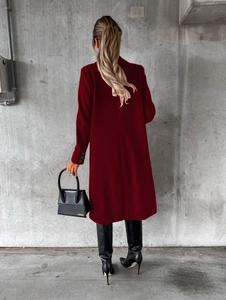 Back view of burgundy double-breasted coat with slim fit cut and rear vent detail