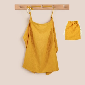 Close-up of mustard yellow cotton muslin nursing cover set with matching storage bag