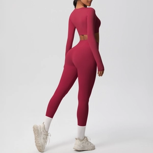 Rear view detail of rouge red nylon yoga set showing sculpting high waist leggings and crop top