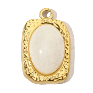 Detail of a rectangular gold-plated pendant with hammered texture and oval white stone