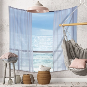 Detail showing Bohemian tapestry with sea view through curtains on a textured wall
