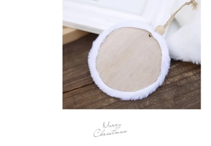 Detail of wooden Christmas ornament with white faux fur trim and Merry Christmas script