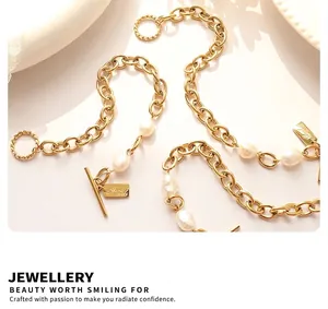 Close-up of golden link chain bracelet with baroque pearls and OT clasp detail