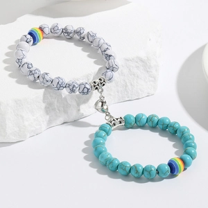 Detail of magnetic heart clasp connecting white marble and turquoise beaded friendship bracelets