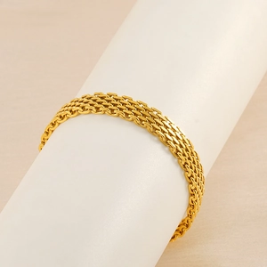 Luxurious gold woven mesh chain bracelet in stainless steel displayed on a stand