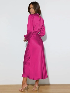Detail of fuchsia satin dress showing the waist elastic and smooth drape of the fabric