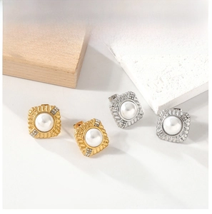 Detail of vintage square pearl earrings with textured metal frame and tiny crystal accents