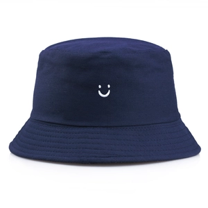 Navy blue cotton bucket hat with white smiley face embroidery for sun protection