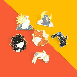 Detailed view of six enamel pins featuring celestial rabbits, foxes, and koi fish designs