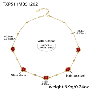 Detail view of gold stainless steel necklace with five red faceted glass stones and clasp