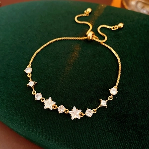 Macro detail of gold-plated adjustable star bracelet with sparkling cubic zirconia stones