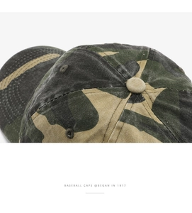 Close-up of camouflage baseball cap crown showing washed canvas texture and ventilation holes