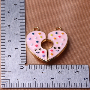 Detail shot of heart-shaped magnetic pendants showing dimensions with a ruler tool