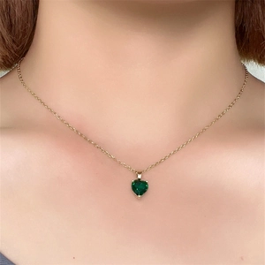 Close-up of heart-shaped emerald green zircon pendant with gold plated stainless chain