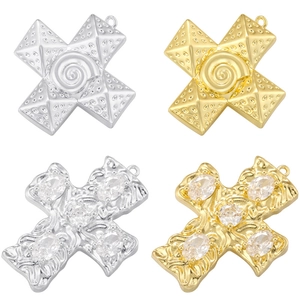 Detailed view of hip hop cross pendants in gold and silver finishes with crystal accents