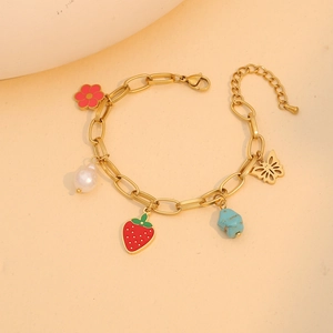 Golden bracelet with colorful charms featuring strawberry, flower and butterfly pendants