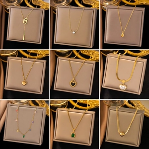 Golden titanium steel necklace collection featuring diverse charms and elegant designs