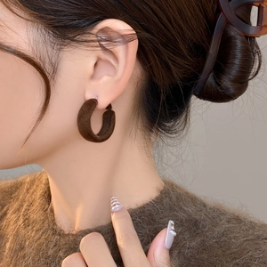 Classic deep red velvet flocked C-shaped hoop earrings for women shown on model