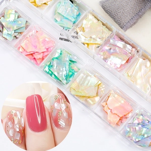 Macro detail of iridescent shell flakes for nail art in a 12-slot organizer box