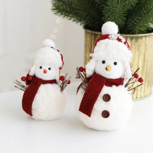 Festive red and white plush snowman figurines with green pine needles decorations