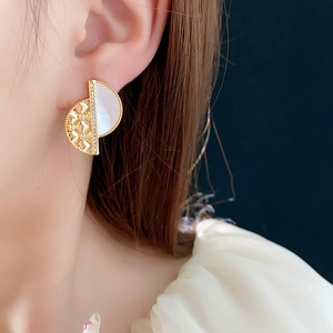 Close-up of geometric 18K gold plated stud earrings with quilted pattern and zircon stones