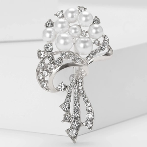 Macro detail of elegant silver floral brooch with pearls and sparkling crystal rhinestones