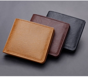 Close-up of stacked short leather wallets in black, light brown, and dark brown colors
