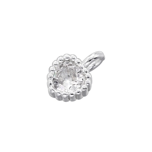 Macro shot of a small silver pendant featuring a clear round gemstone with beaded metal edges