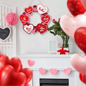 Valentine's Day heart wreath with Happy Valentine's Day sign hanging on a fireplace