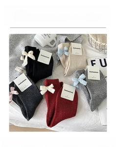 Detail of wool blend crew socks with decorative bows in five versatile autumn colors