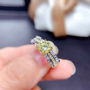 Detailed shot of two-tone ring with yellow moissanite and pave stones setting