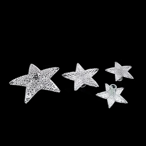 Detailed view of silver star-shaped Christmas tree toppers with textured finish and connectors