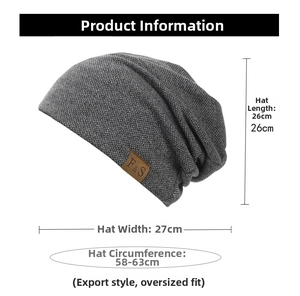 Detail of dark grey knit beanie featuring a brown leather label with size dimensions