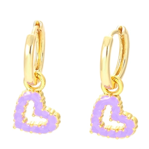 Detailed close-up of golden hoop earrings featuring purple hollow heart-shaped pendants