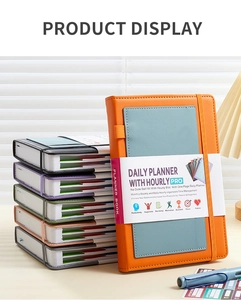 Detail of colorful daily planners with elastic bands and pen holders on leather covers