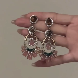 Vintage style floral pendant earrings with pink crystals and gold tone finish