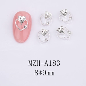 Detailed view of silver heart nail art charms with crystals on pink manicure