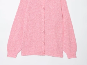 Detailed macro view showing the fuzzy mohair texture and matching pink buttons of the cardigan
