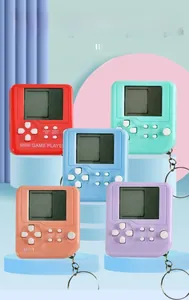 Five colorful mini handheld game consoles with LCD screens and keychain attachments